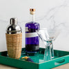 bar cart collection with rattan wrapped martini shaker hammered stem martini glasses bar tray